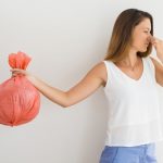 woman smelling garbage